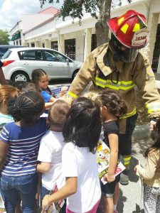 Children with firefighter outside of Montessori School of Davenport.