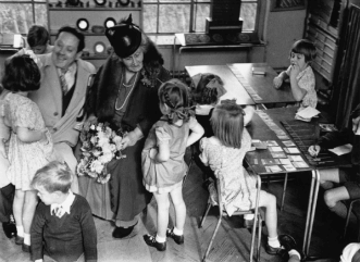 Maria Montessori with children in classroom (Black & White photograph)